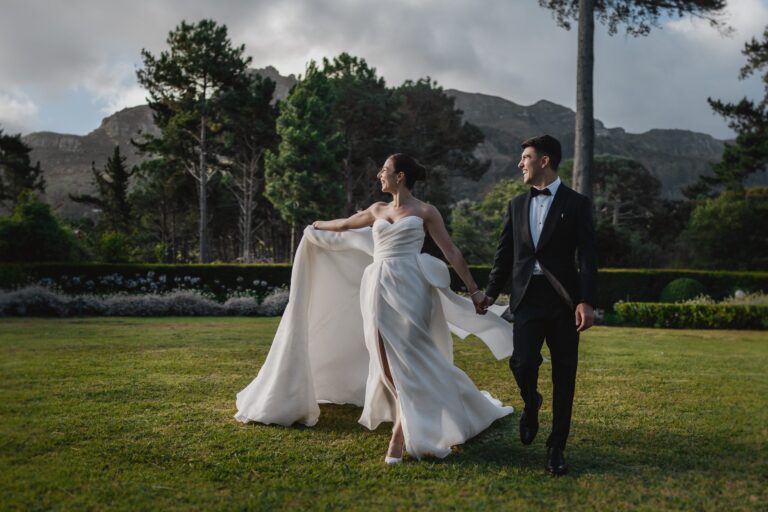 A bride and groom walking on the lawn with the mountain behind, The Forum Embassy Hill