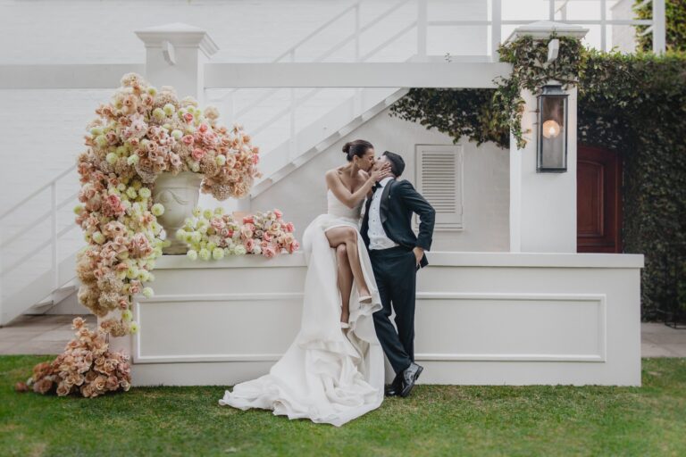 A couple beside a floral installation at the house, The Forum Embassy Hill