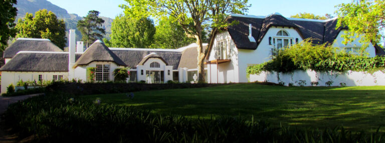 The thatched house seen across the lawn, The Forum Embassy Hill
