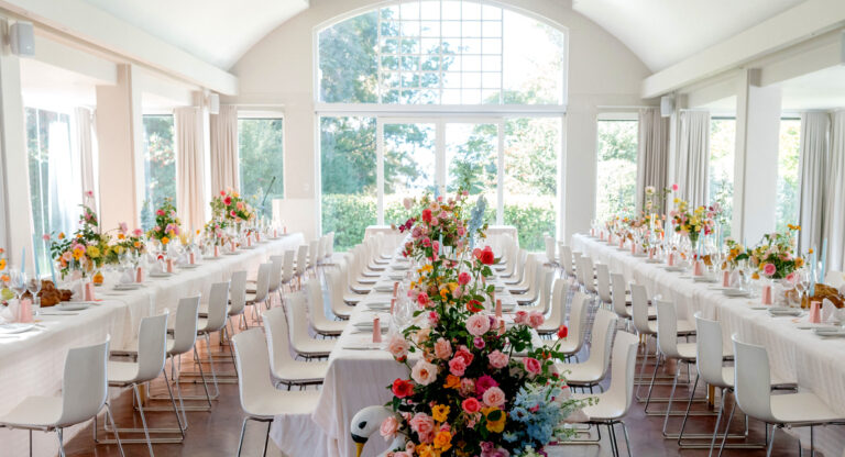The light-filled hall set with long tables and flowers, The Forum Embassy Hill