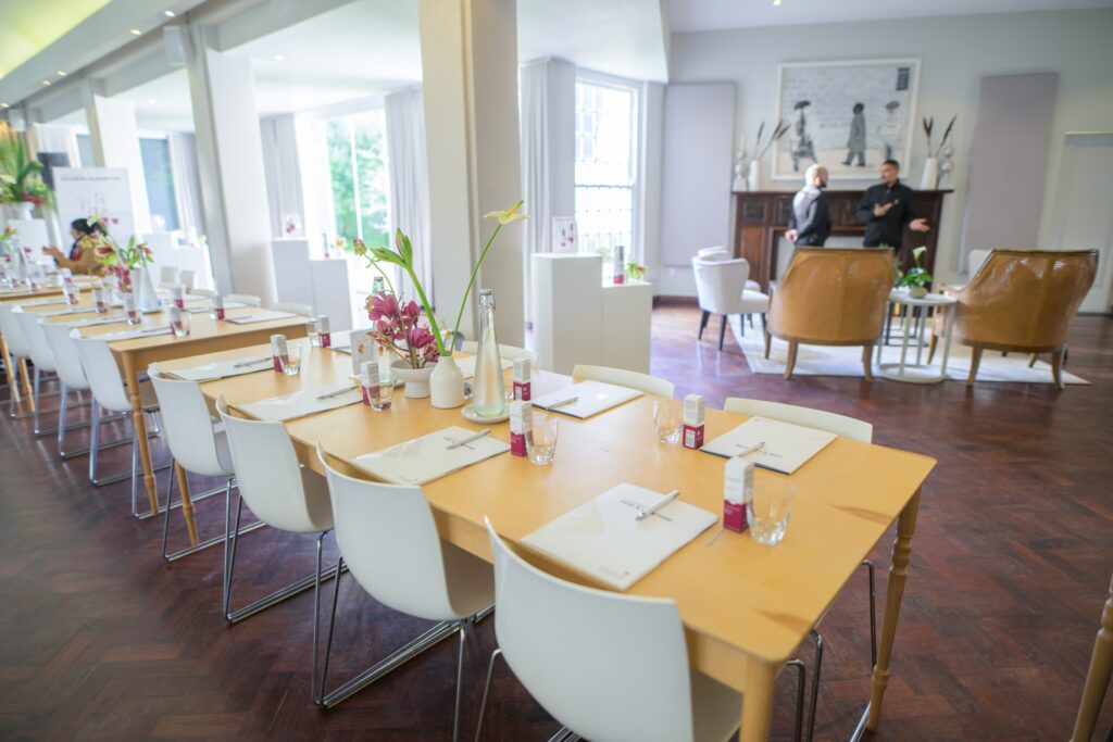 An indoor space set with long tables, The Forum Embassy Hill