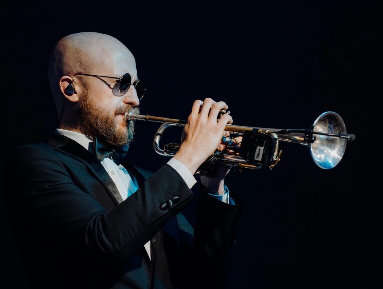 Trumpeter performing in a dark room, The Function Band