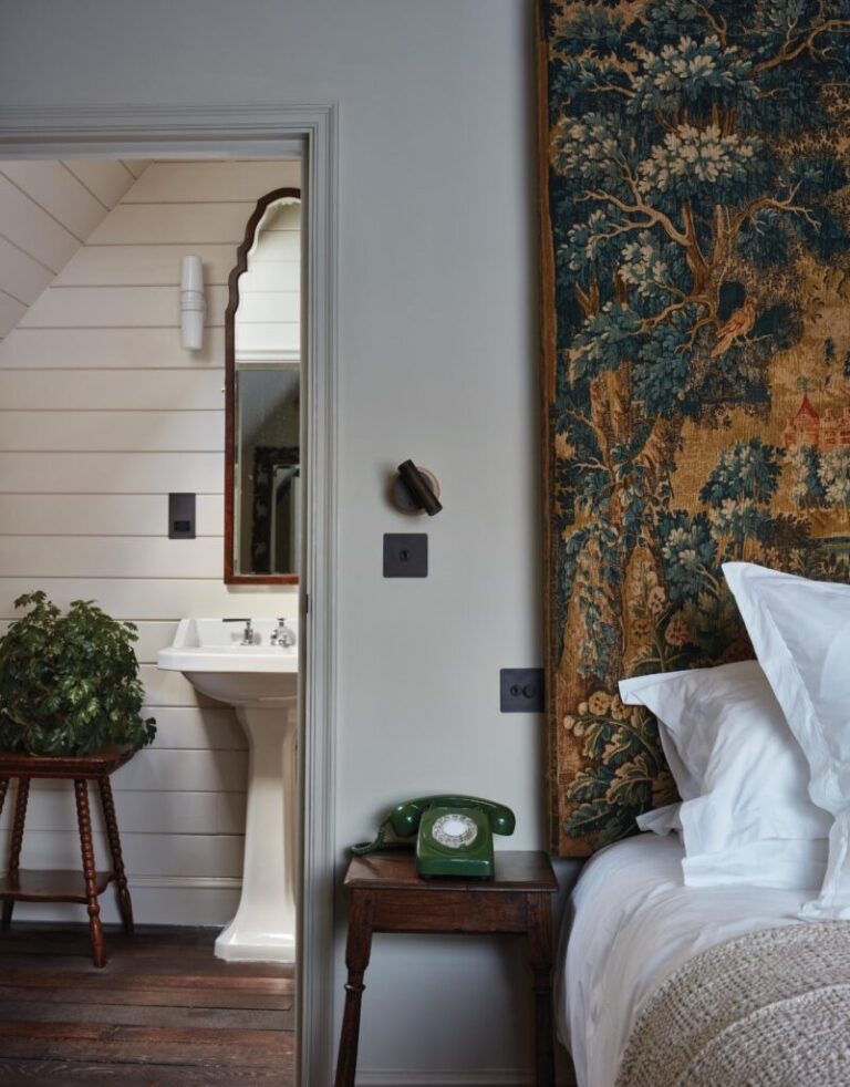 A bedroom with a tapestry headboard and roll-top basin, The George in Rye