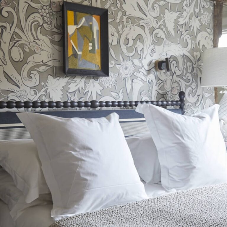 A George bedroom in patterned wallpaper and crisp white linen, The George in Rye