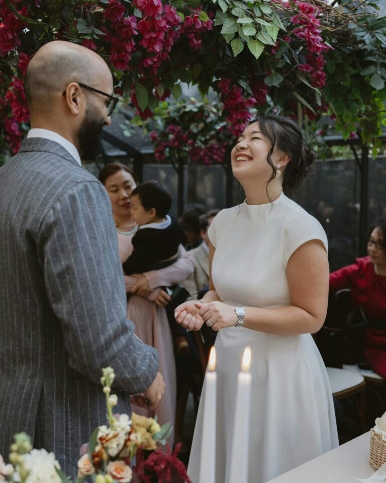 The couple during the ceremony, guests gathered close, The Greenhouses