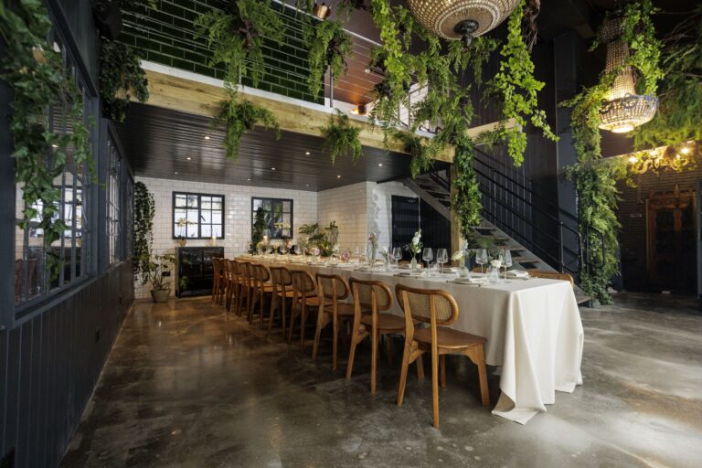 The City greenhouse, long table under foliage with the mezzanine stair, The Greenhouses
