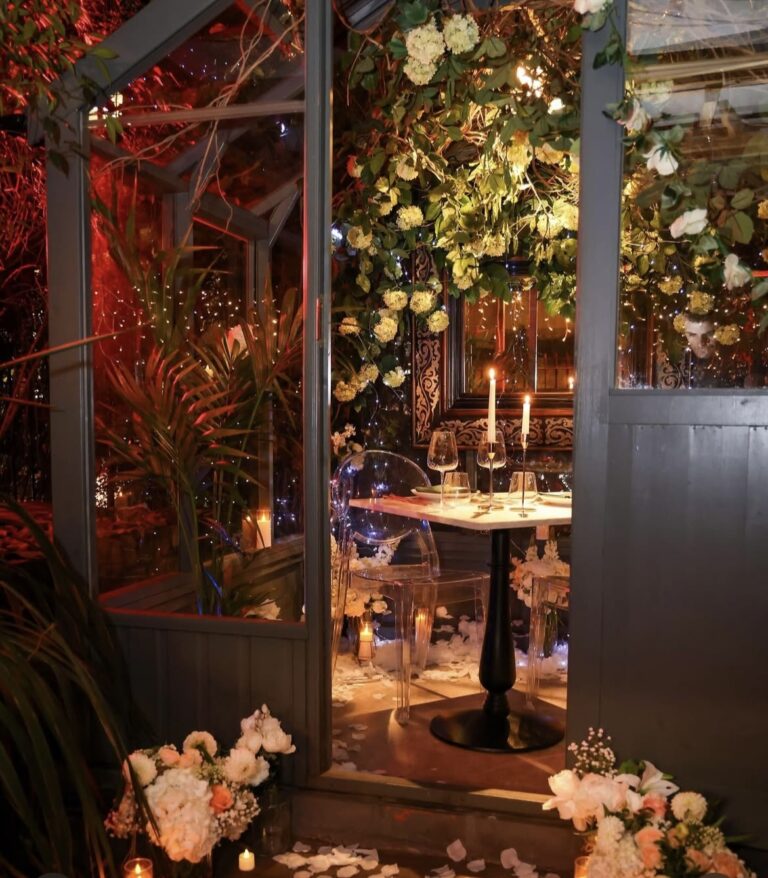 An intimate candlelit table for two in the Lovers Greenhouse, The Greenhouses