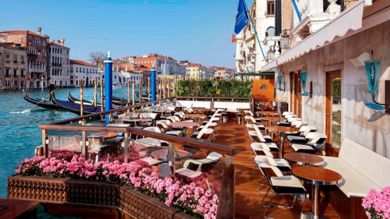 A terrace with pink blooms over the Grand Canal, The Gritti Palace