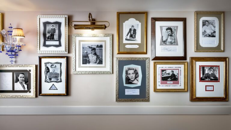 A grand palazzo corridor hung with paintings, The Gritti Palace