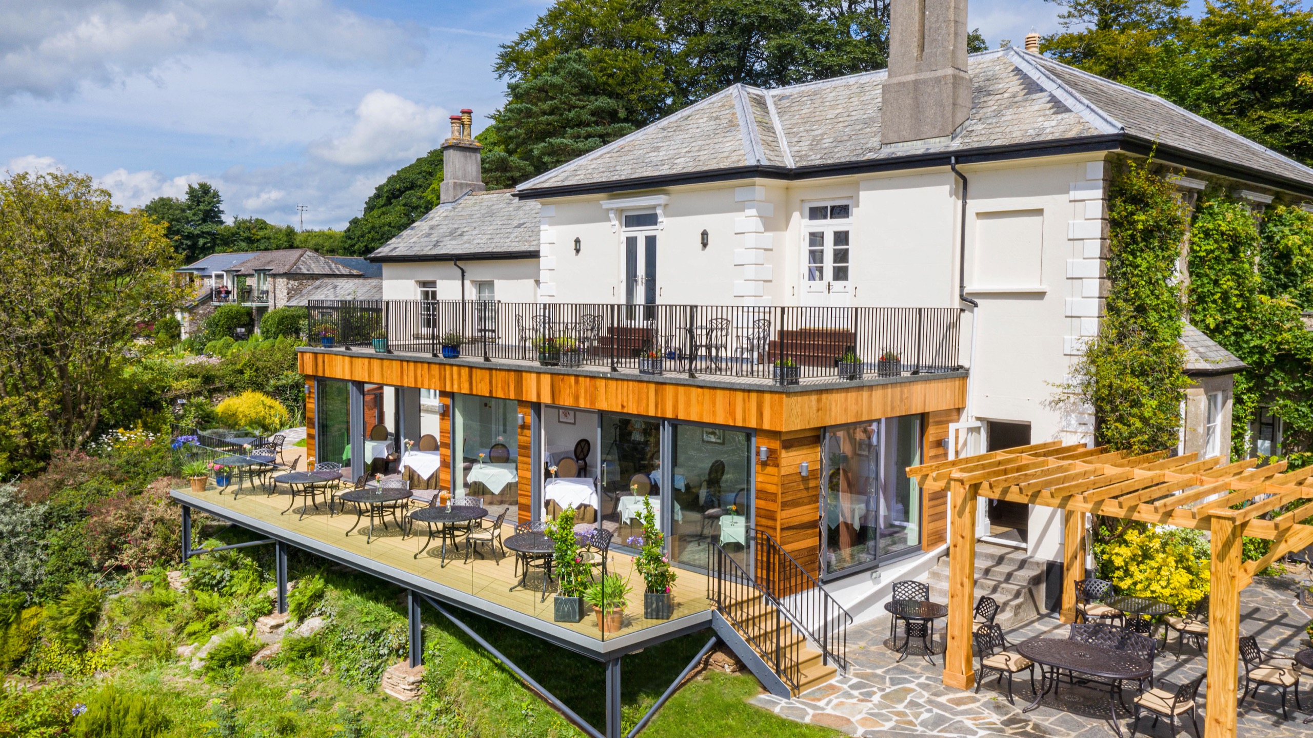 Aerial view of the Main House with the glass-fronted restaurant, terrace and pergola stepping down into the gardens, The Horn Of Plenty