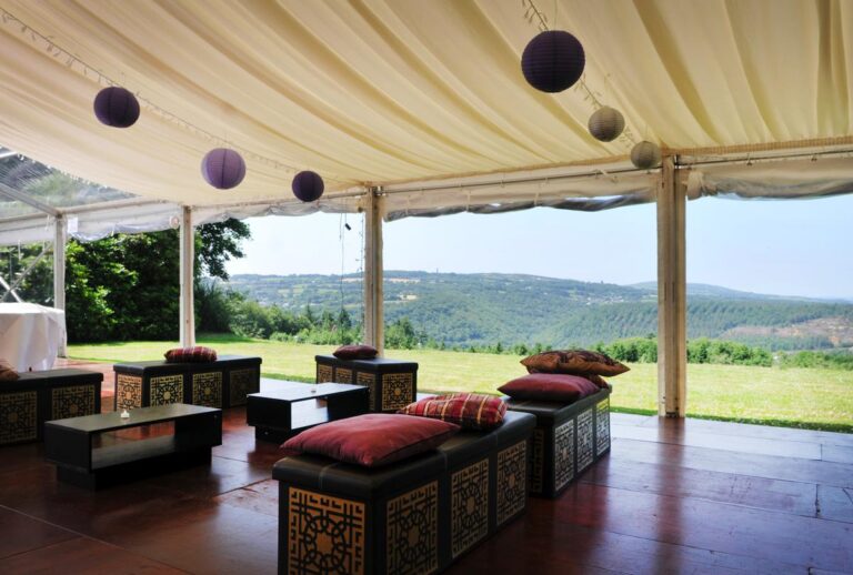 Inside a marquee on the lawn, laid out with low lounge seating and paper lanterns, open to the countryside, The Horn Of Plenty