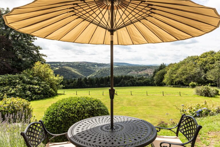 Garden tables on the lawn above the Tamar Valley, looking west towards Cornwall, The Horn Of Plenty