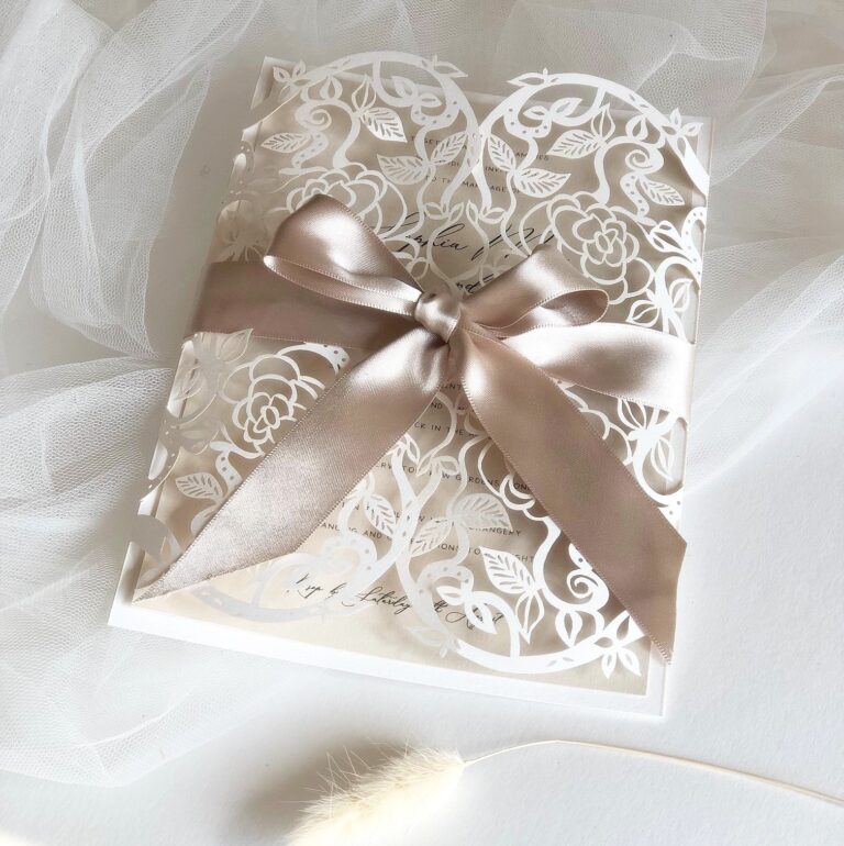 Laser cut lace gatefold invitation tied with a taupe ribbon, The Hummingbird Card Company