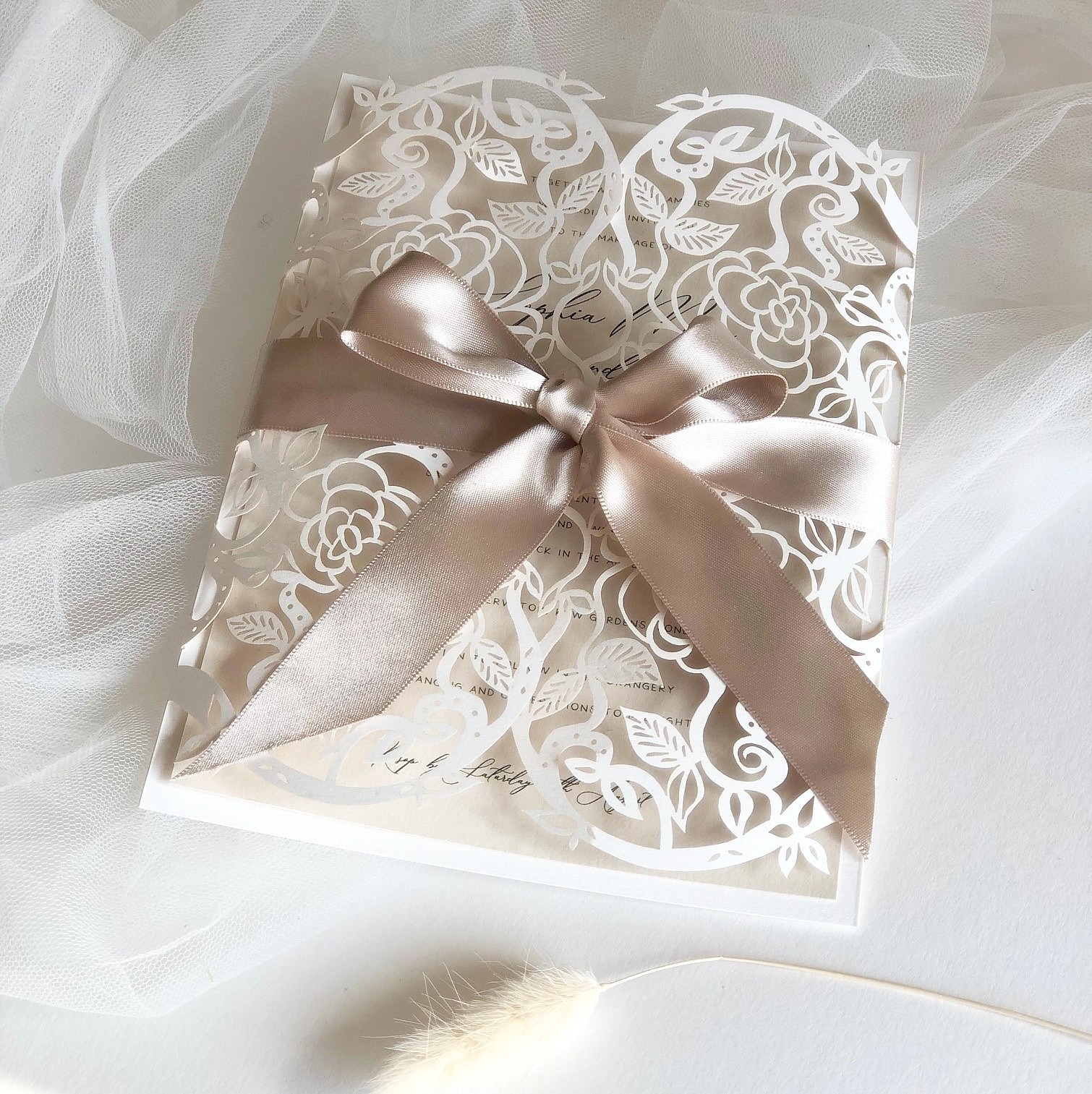 Laser cut lace gatefold invitation tied with a taupe ribbon, The Hummingbird Card Company