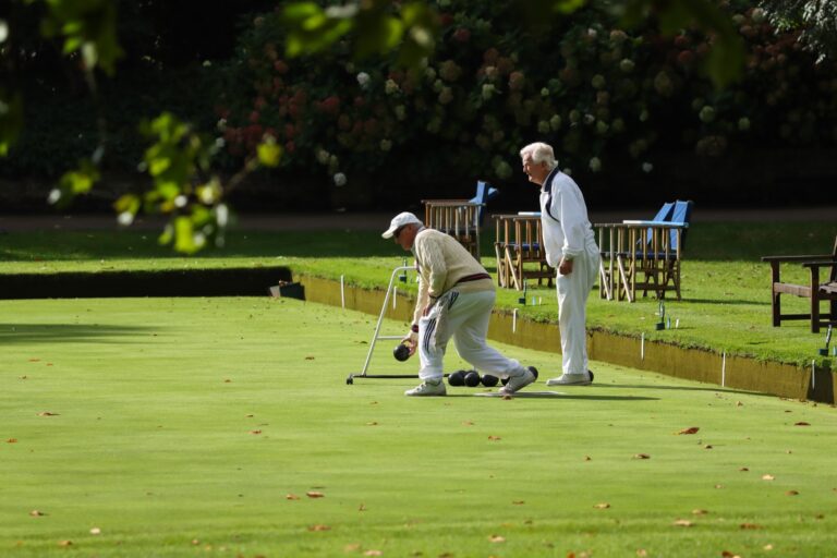 Players in whites at a lawn game on the club’s greens, The Hurlingham Club