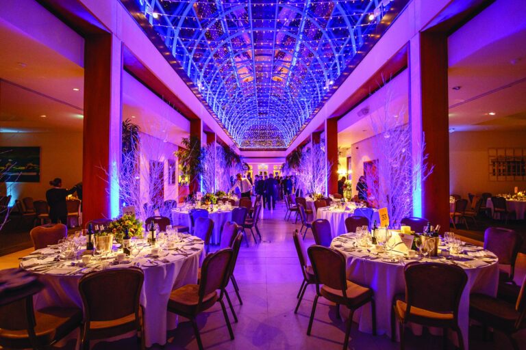 Palm Court set for a dinner-dance, round tables beneath the illuminated dome, The Hurlingham Club