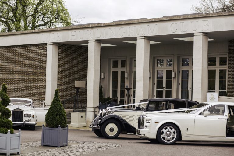 Vintage wedding cars drawn up at the club’s pillared entrance, The Hurlingham Club