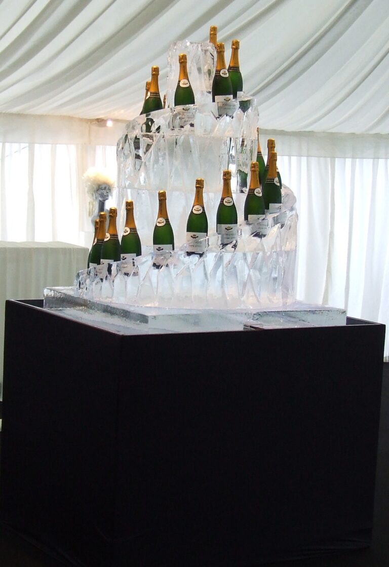 A stepped ice display holding champagne bottles inside a marquee, The Ice Box