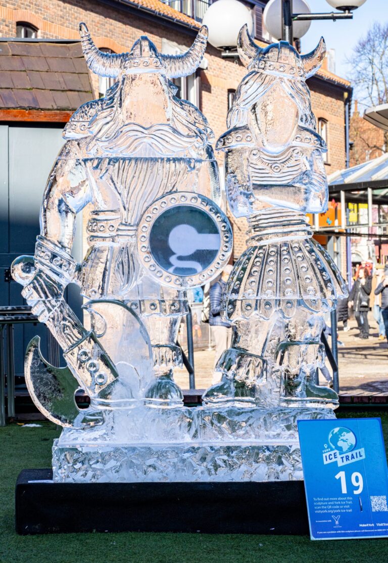 Two carved ice Viking figures in a city courtyard, The Ice Box
