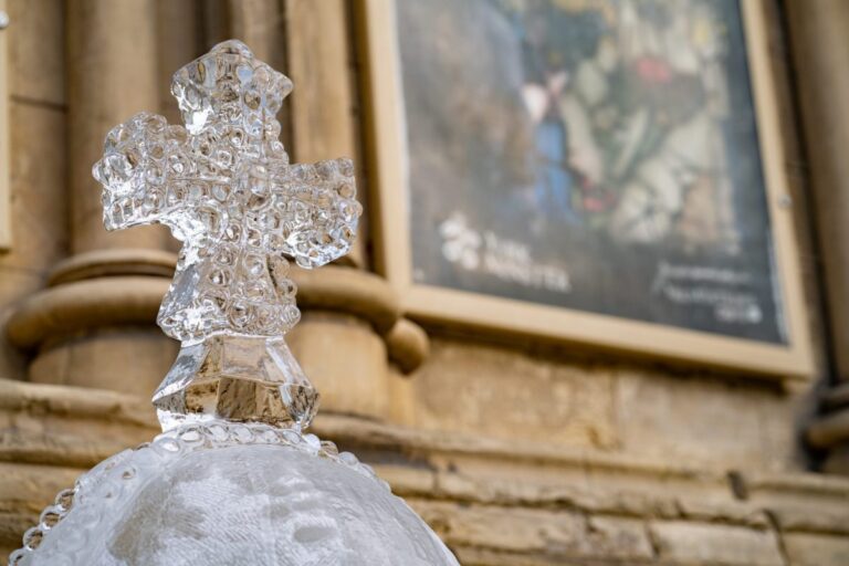 A carved ice orb and cross against the stone of York Minster, The Ice Box