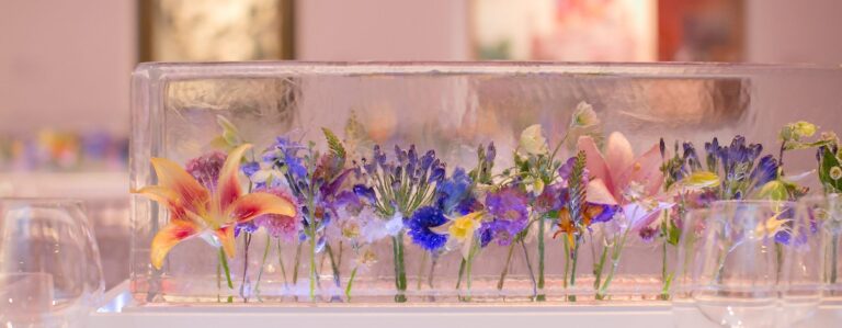 A long ice trough of mixed flowers along a banquet table, The Ice Box