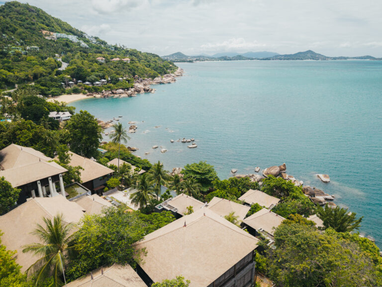 Aerial view of the resort roofs and the bay beyond, The Kala Samui