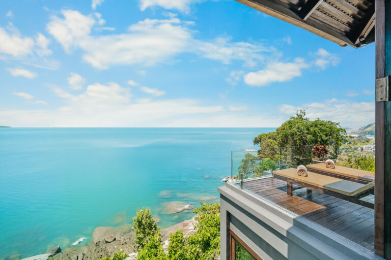 Sea-view terrace with a glass balustrade above the water, The Kala Samui