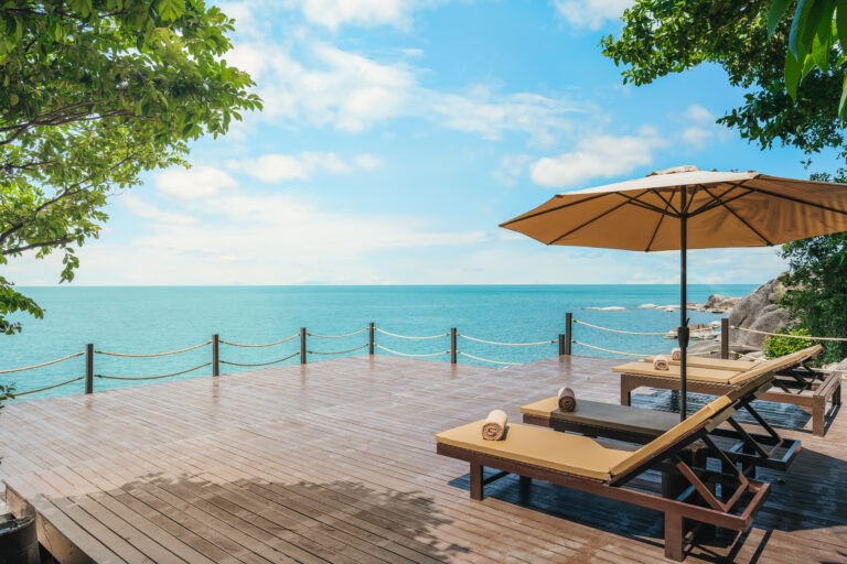 Sun deck with an umbrella and loungers by the sea, The Kala Samui