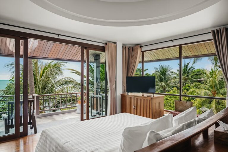 Bedroom with a king bed and sea-view balcony doors, The Kala Samui