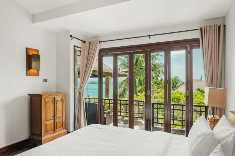 Bed and balcony doors opening onto the view, The Kala Samui