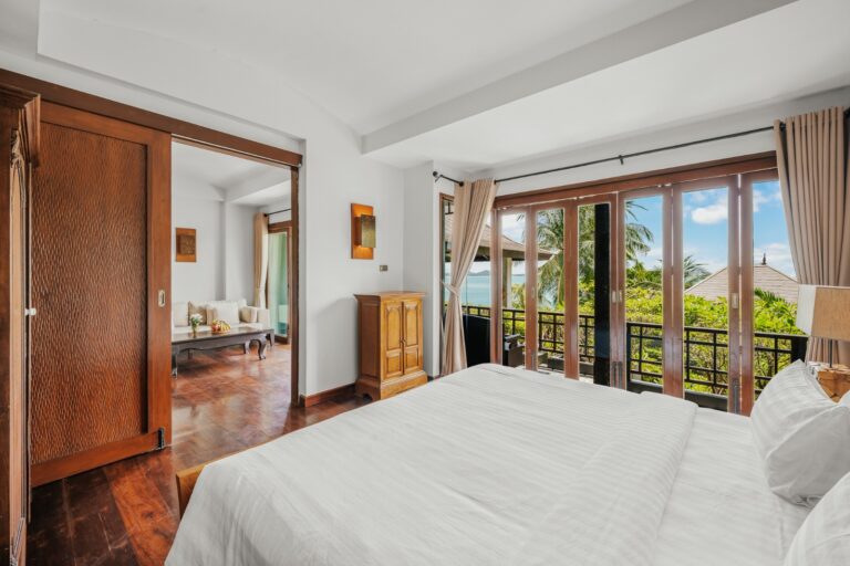 Bedroom with balcony doors and a seating area beyond, The Kala Samui