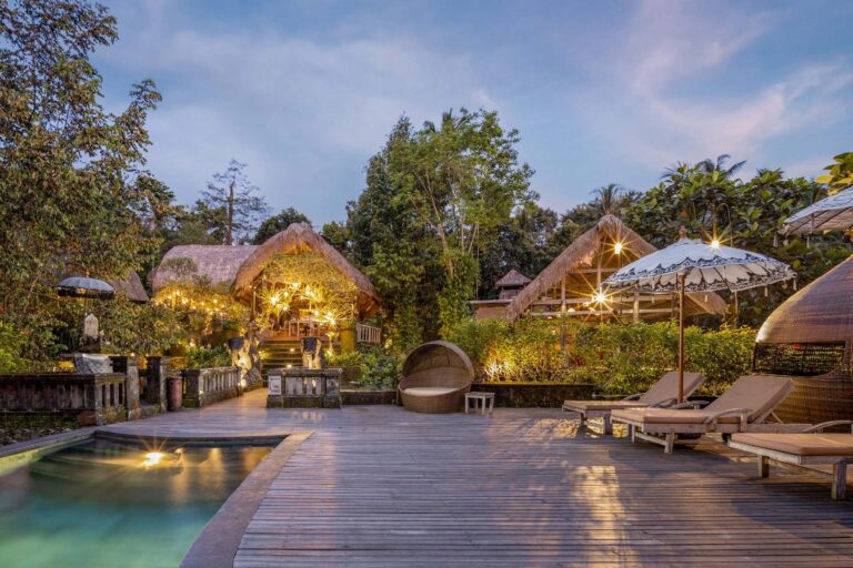 The pool deck and thatched pavilions at dusk, The Kayon Ubud Resort