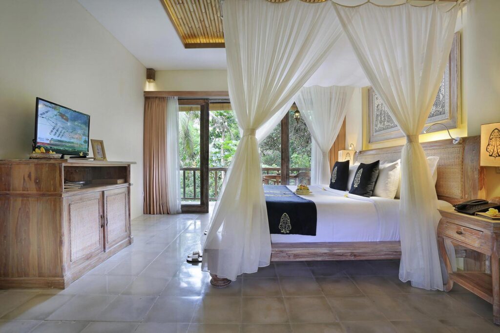 Suite bedroom with canopy bed and jungle view, The Kayon Ubud Resort