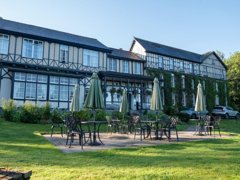The mock-Tudor facade with garden parasols on the lawn, The Lake Country House Hotel & Spa