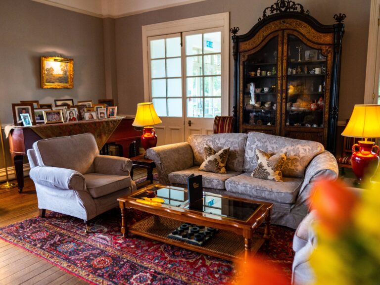 A sitting room with sofas and portraits, The Lake Country House Hotel & Spa