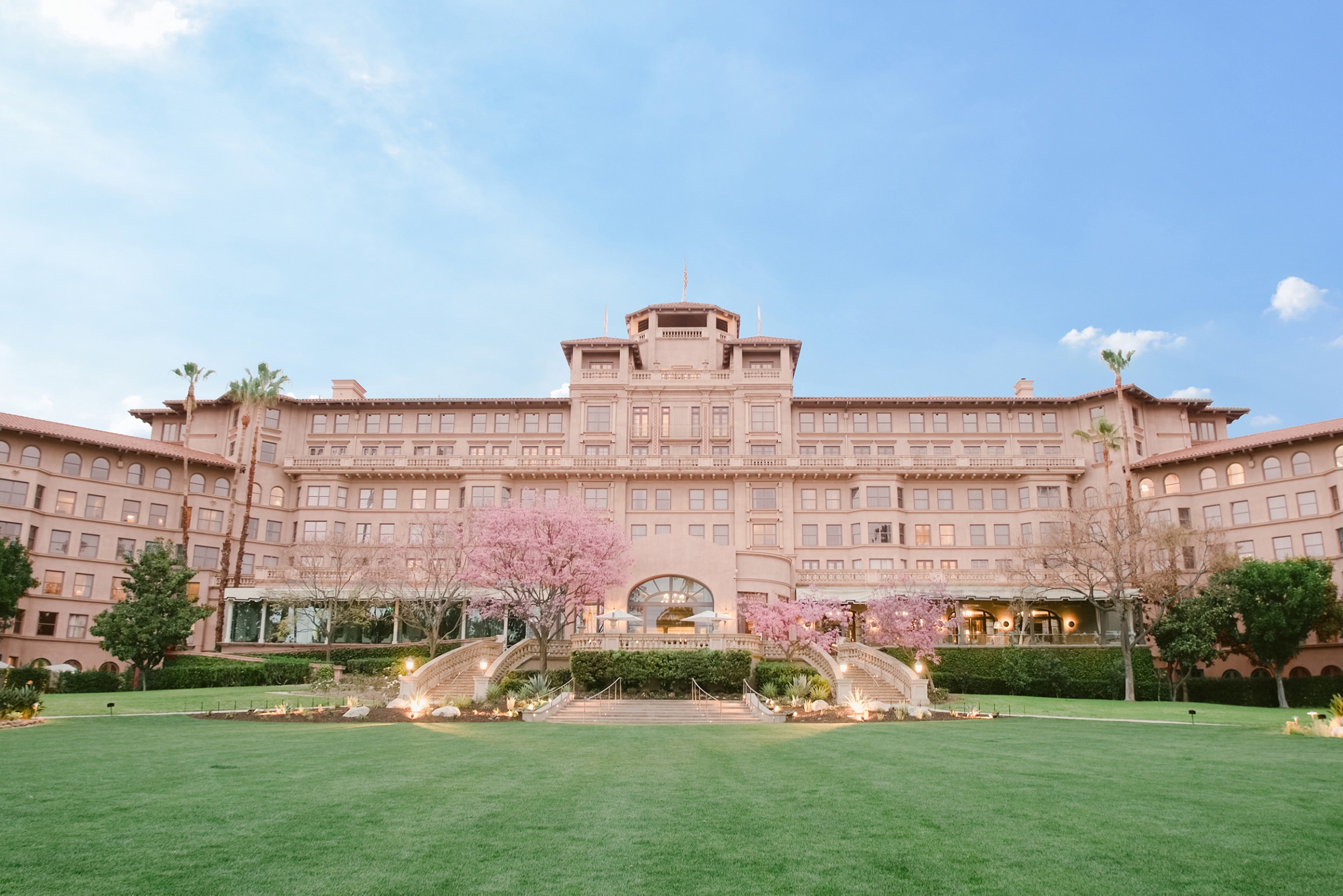 The pink-stuccoed main hotel seen across the Horseshoe Garden lawn, The Langham Huntington Pasadena