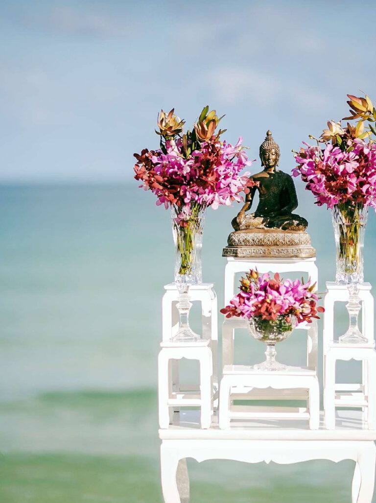 Buddha altar with flowers set up on the beach for a Thai ceremony, The Library