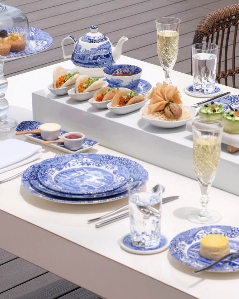 High tea table set with blue-and-white porcelain, canapes and sparkling wine, The Library