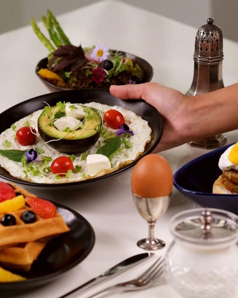 Breakfast spread of fruit, eggs and waffles, The Library