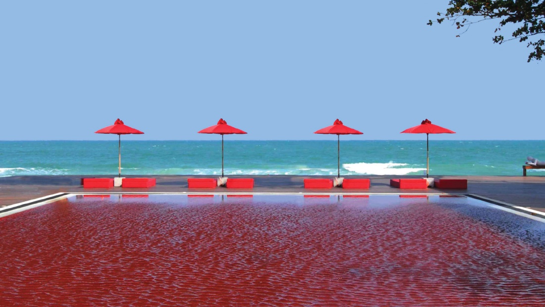 The Red Pool with red parasols and loungers facing the sea, The Library