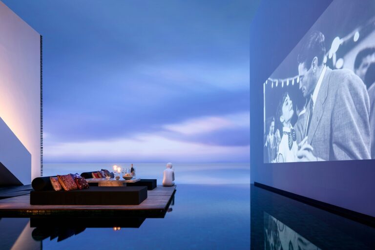 Floating lounge deck and outdoor cinema screen over the pool at The Writer, The Library