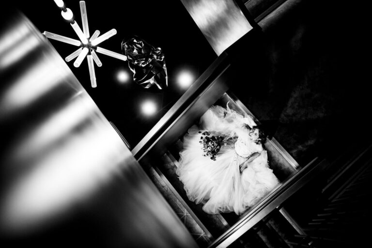 A bride seen from above through the bronze staircase, in black and white, The Londoner