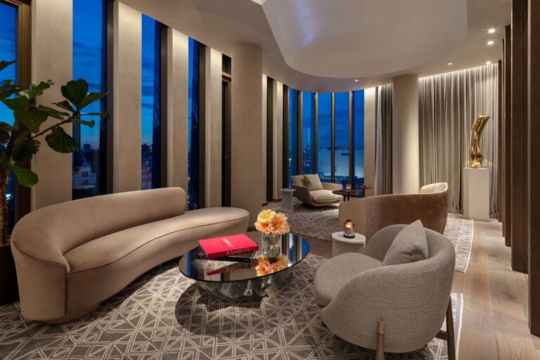 The living room of the two-storey Tower Penthouse Suite, with curved sofas and city views, The Londoner