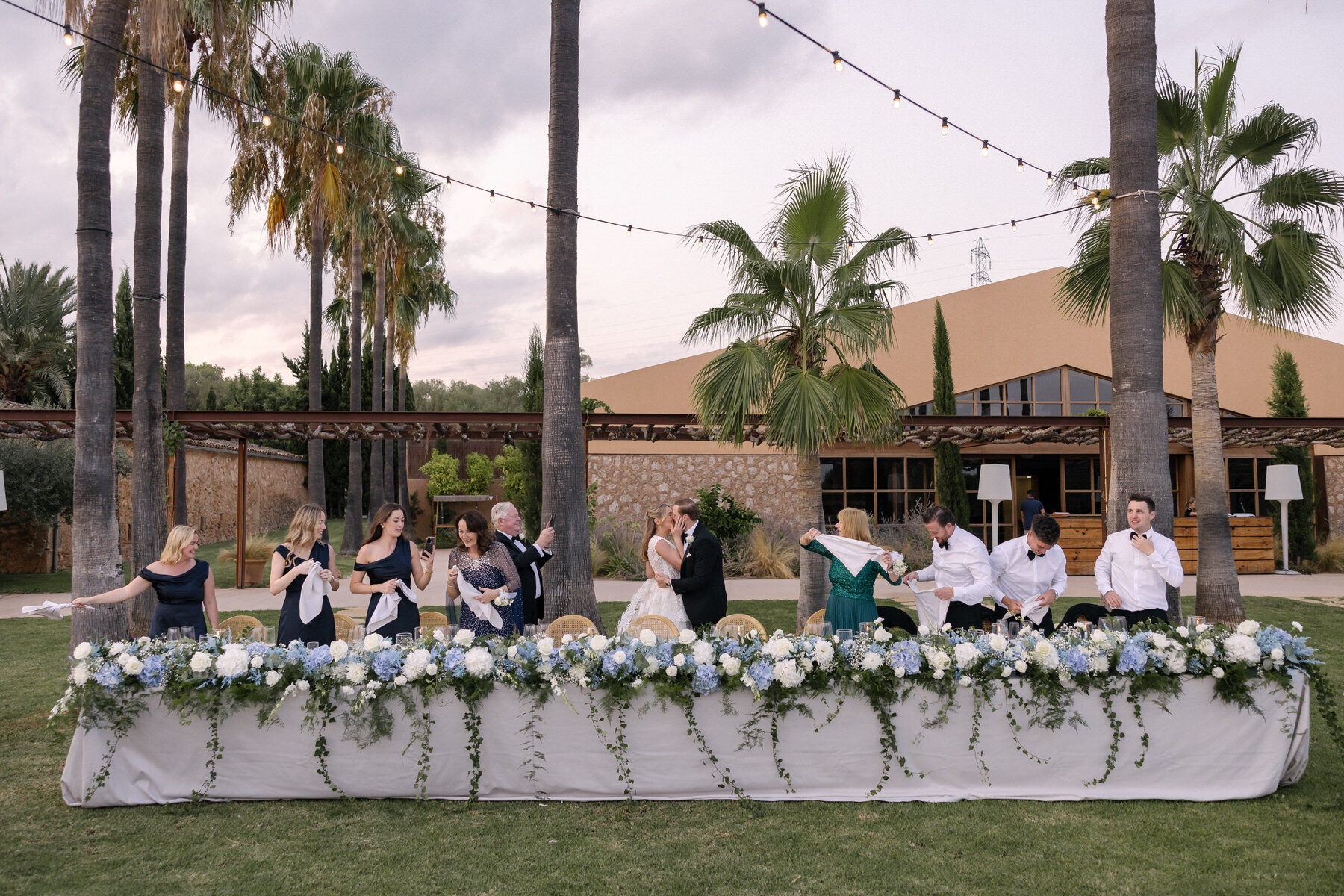 A long table set beneath the palms, The Mallorca Wedding Company