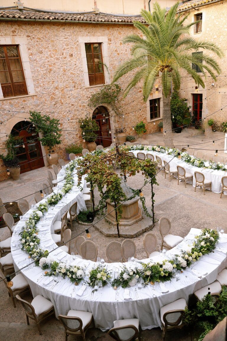 Long tables around the courtyard well, The Mallorca Wedding Company
