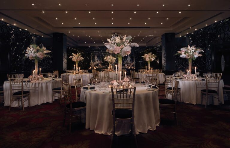 The Danziger Suite set with round tables, Chiavari chairs and tall lily centrepieces, The May Fair