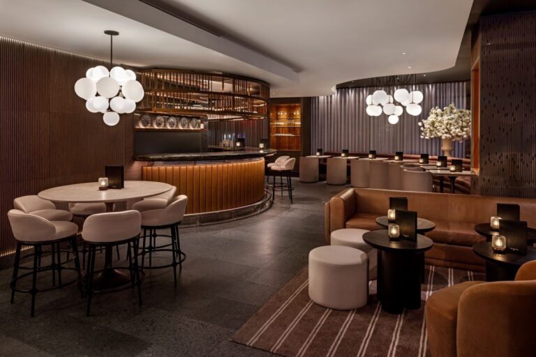 The May Fair Bar with a curved bar counter, round tables and globe pendant lights, The May Fair