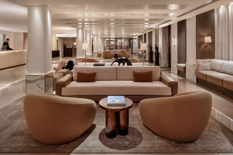 The hotel lobby lounge with cream sofas, round armchairs and white columns, The May Fair