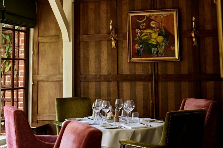 The Terrace Restaurant, wood-panelled with a still-life oil and velvet chairs, The Montagu Arms Hotel
