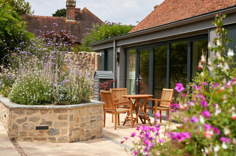The courtyard terrace with raised stone planters and outdoor seating, The Montagu Arms Hotel
